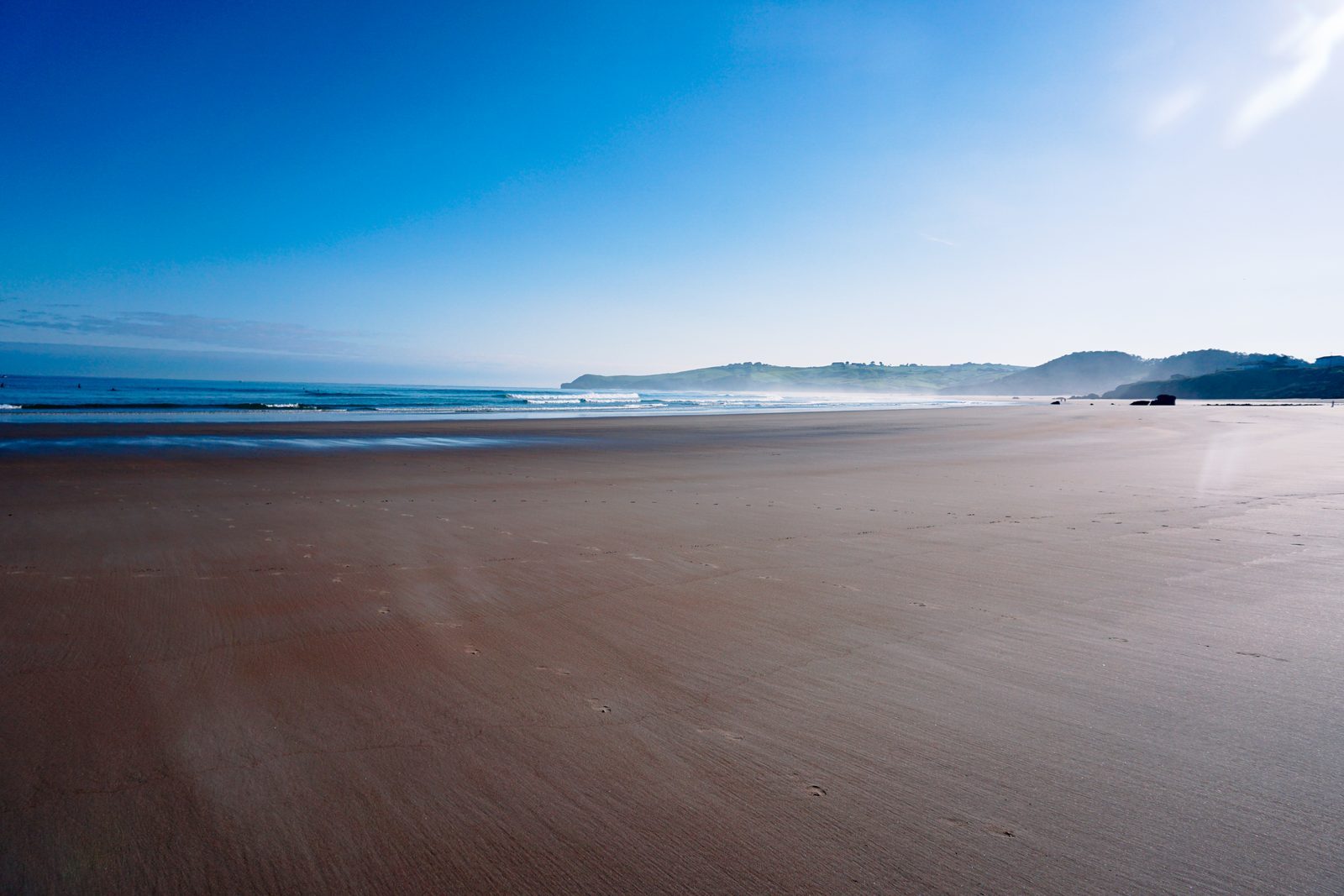 Like an endless shoreline stretching toward gentle hills, love asks only for quiet presence, patient footprints, and the shared horizon we walk toward together.