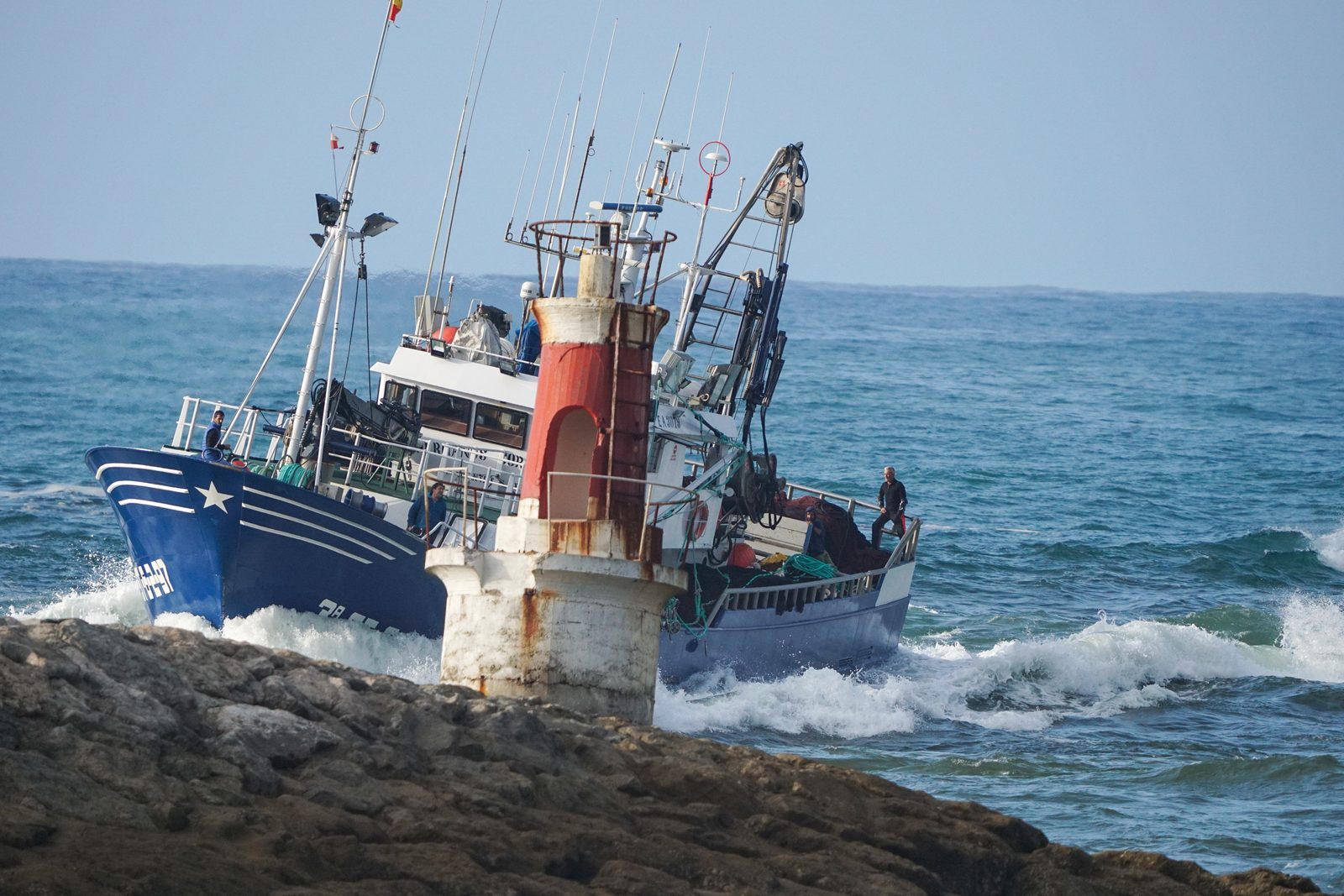 Guided past the old harbor light, the fishing boat returns home through the waves, carrying the quiet devotion of those who wait on shore.